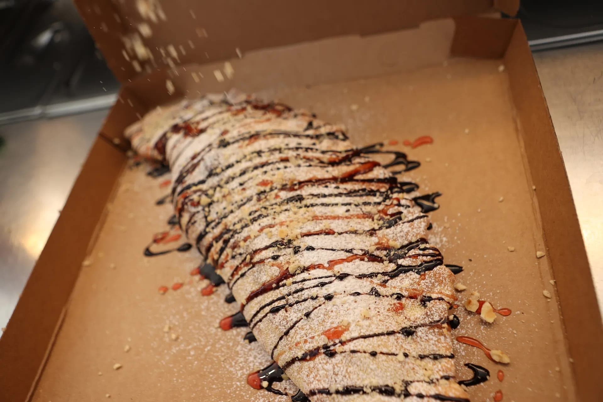 Sweet calzone with chocolate, berry sauce, and powdered sugar at Dieci Mykonos